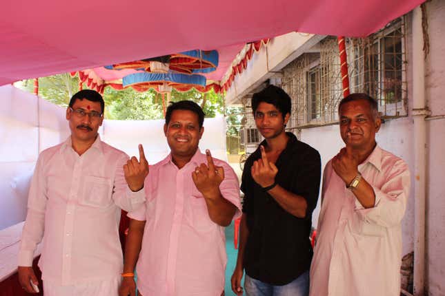 Members of the Shiv Sena show their marked fingers after voting