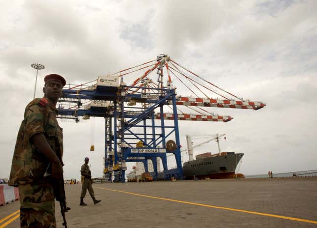 FILE PHOTO: A Djibouti policeman stands guard during the opening ceremony of Dubai-based port operator DP World's Doraleh container terminal in Djibouti port February 7, 2009.