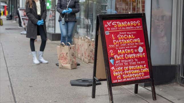 April 2020: a sandwich board lists Trader Joe's COVID protocols, including masks and distancing