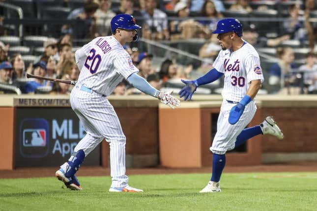 Aug 13, 2023; New York City, New York, USA; New York Mets center fielder Rafael Ortega (30) is greeted by first baseman Pete Alonso (20) after scoring in the third inning against the Atlanta Braves at Citi Field.