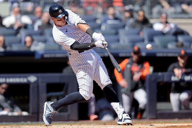 Mar 30, 2023; Bronx, New York, USA; New York Yankees center fielder Aaron Judge (99) hits a solo home run against the San Francisco Giants during the first inning at Yankee Stadium.