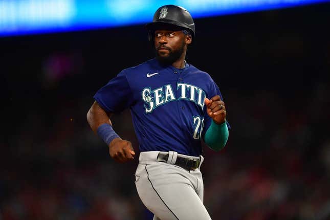 June 25, 2022; Anaheim, California, USA; Seattle Mariners pinch runner Taylor Trammell (20) reaches third against the Los Angeles Angels during the seventh inning at Angel Stadium.