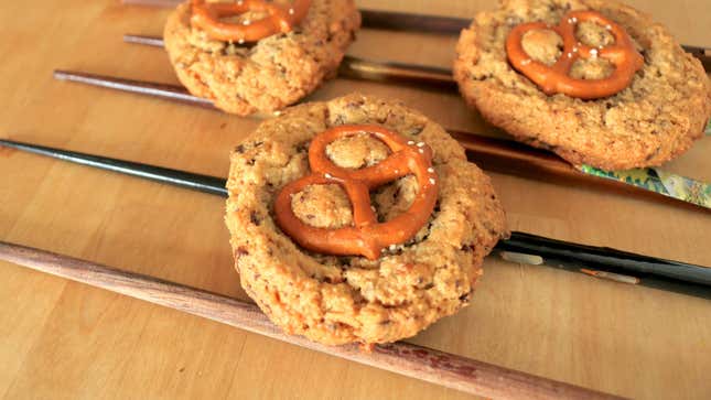 Three cookies on top of evenly arranged chopsticks.