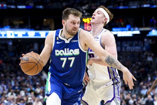 Apr 5, 2023; Dallas, Texas, USA;  Dallas Mavericks guard Luka Doncic (77) drives to the basket as Sacramento Kings guard Kevin Huerter (9) defends during the second quarter at American Airlines Center.