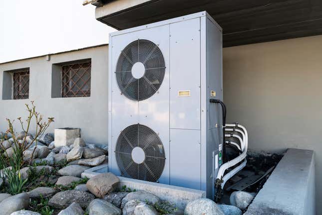 The external fan box of a geothermal heat pump system on the side of a building.