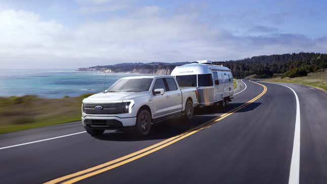 A rendering of the Ford F-150 Lightning driving along the coast.