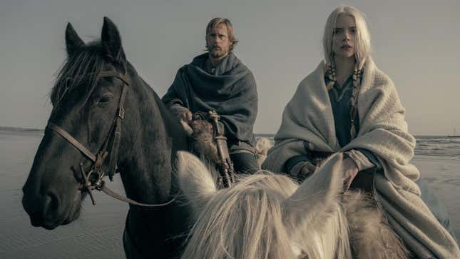 Alexander Skarsgård and Anya Taylor-Joy on horses on a beach.