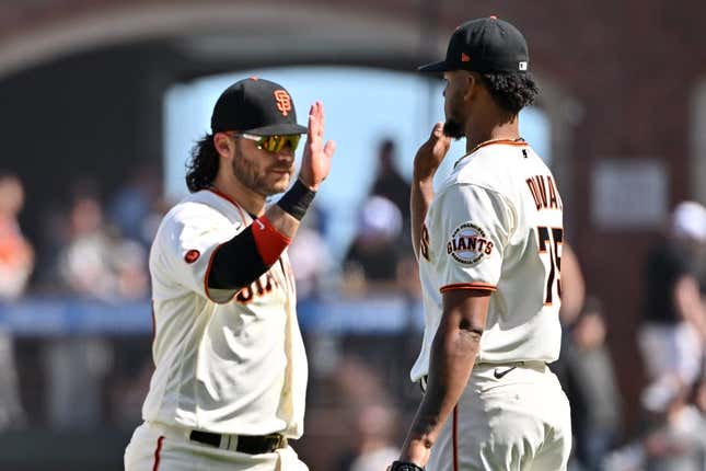 Apr 22, 2023; San Francisco, California, USA; San Francisco Giants pitcher Camilo Doval (75) shakes hands with infielder Brandon Crawford (35) after the final out of the ninth inning against the New York Mets at Oracle Park.