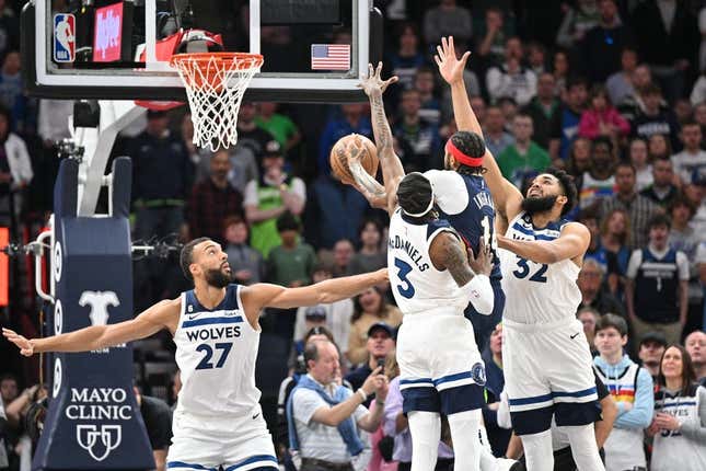 Apr 9, 2023; Minneapolis, Minnesota, USA; New Orleans Pelicans forward Brandon Ingram (14) goes to the basket as Minnesota Timberwolves center Karl-Anthony Towns (32), forward Jaden McDaniels (3) and center Rudy Gobert (27) defend during the first quarter at Target Center.
