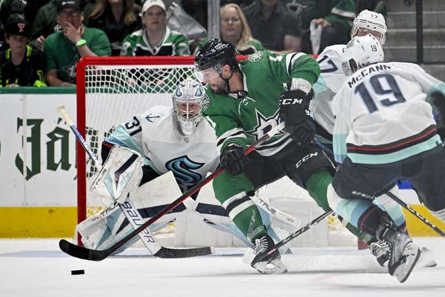 May 15, 2023; Dallas, Texas, USA; Dallas Stars center Luke Glendening (11) attempts to poke a shot past Seattle Kraken goaltender Philipp Grubauer (31) on a short handed attempt in the Seattle zone during the first period in game seven of the second round of the 2023 Stanley Cup Playoffs at the American Airlines Center.