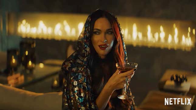 A vampiric Megan Fox sups at her drink in a scene from Night Teeth.