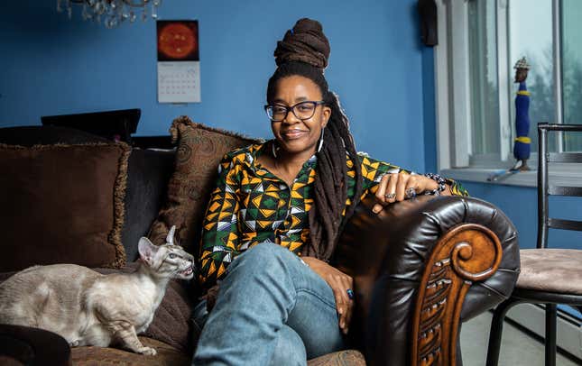 Nnedi Okorafor with her cat Periwinkle Chukwu at her home in Flossmoor, Ill. on Monday, Feb. 4, 2019.