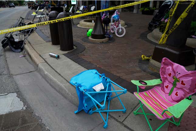 Empty chairs, a bicycle, and a stroller are seen after a mass shooting at  the Highland Park Fourth of July parade in downtown Highland Park,  Ill., a Chicago suburb, on Monday, July 4, 2022.