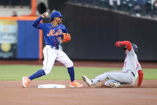Apr 26, 2023; New York City, New York, USA; New York Mets shortstop Francisco Lindor (12) throws to first base over Washington Nationals left fielder Alex Call (17) while attempting to complete a double play in the first inning at Citi Field.