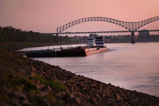 A tug holds barges along the rocky shoreline of the Mississippi River on October 18, 2022 in Memphis, Tennessee.