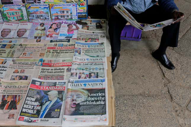 A Kenyan newspaper vendor (R) reads a newspaper featuring front page article about US President-elect Donald Trump as he waits for customers at a street in Nairobi, Kenya, 10 November 2016. Americans on 08 November chose Republican candidate Donald Trump as the 45th President of the United States of America, to serve from 2017 through 2020.