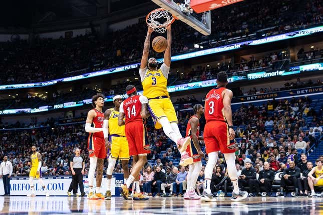 Mar 14, 2023; New Orleans, Louisiana, USA; Los Angeles Lakers forward Anthony Davis (3) dunks the ball against New Orleans Pelicans forward Brandon Ingram (14) during the second half at Smoothie King Center.