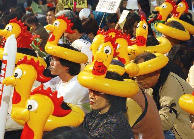 Demonstrators wear inflatable headdresses in the shape of chickens that symbolize the Chinese word for referendum, referring to a referendum on direct elections as more than 1,000 people held a rally and later marched in downtown Hong Kong on Sunday, Jan. 23, 2005, to demand full democracy and social justice in the Chinese territory. The protesters chanted, "Direct elections in 2007 and 2008," the years in which Hong Kong is due a to get new leader and legislature. This former British colony was handed over to Chinese rule in 1997 with a guarantee of democratic political rights that do not exist on the mainland, but many residents who want democracy say Beijing exerts too much control here
