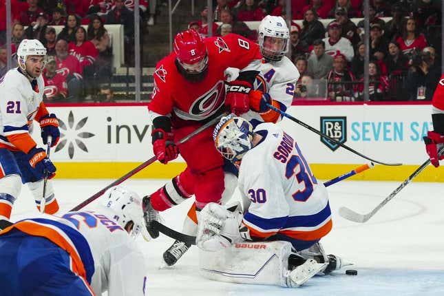 Apr 17, 2023; Raleigh, North Carolina, USA; Carolina Hurricanes defenseman Brent Burns (8) tries to slip the puck past New York Islanders goaltender Ilya Sorokin (30) during the third period in game one of the first round of the 2023 Stanley Cup Playoffs at PNC Arena.