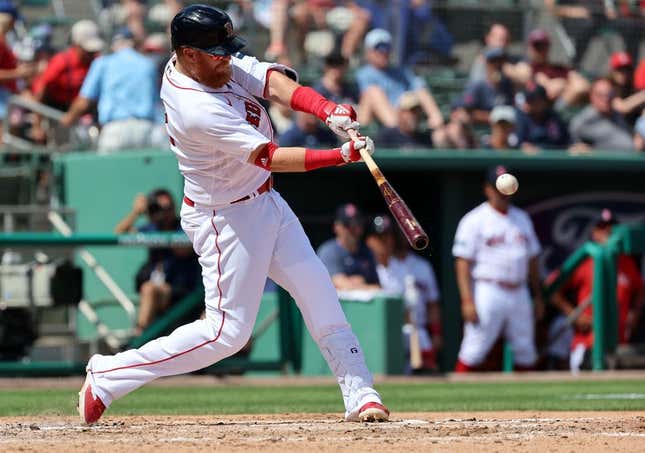 Mar 2, 2023; Fort Myers, Florida, USA; Boston Red Sox third baseman Justin Turner (2) singles during the third inning against the Philadelphia Phillies at JetBlue Park at Fenway South.