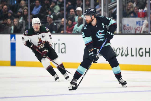 Apr 6, 2023; Seattle, Washington, USA; Seattle Kraken defenseman Adam Larsson (6) plays the puck against the Arizona Coyotes during the first period at Climate Pledge Arena.