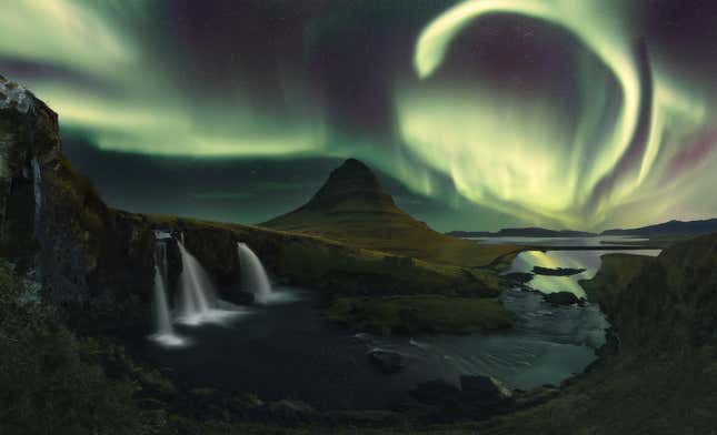A pale yellow hook of light above Iceland.