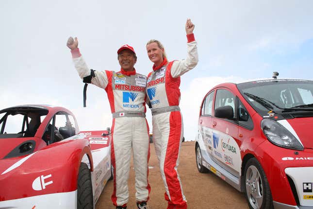 Mitsubishi drivers celebrate after finishing the 2012 Pikes Peak International Hill Climb, in between production and racing versions of the i-MiEV.