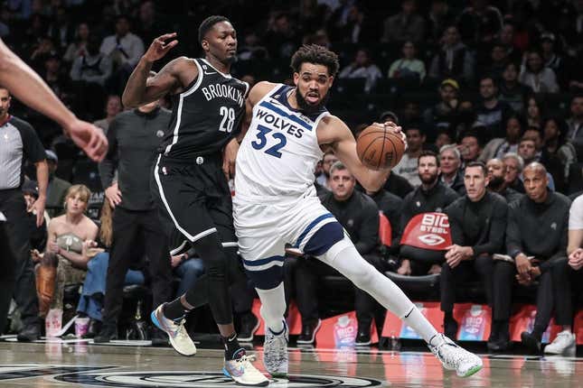 Apr 4, 2023; Brooklyn, New York, USA;  Minnesota Timberwolves center Karl-Anthony Towns (32) looks to drive past Brooklyn Nets forward Dorian Finney-Smith (28) in the first quarter at Barclays Center.