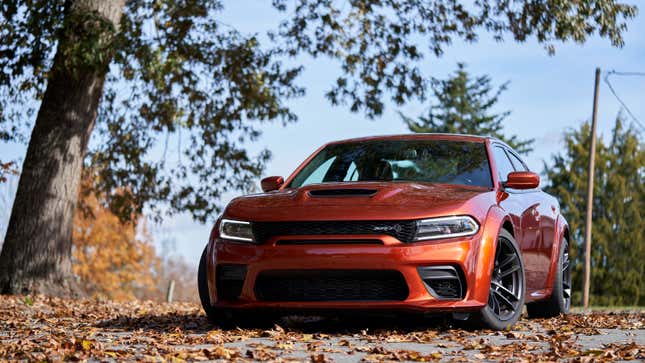 A photo of an orange Dodge Charger muscle car. 