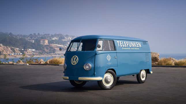 A photo of a blue VW bus with the Telefunken logo on the side. 