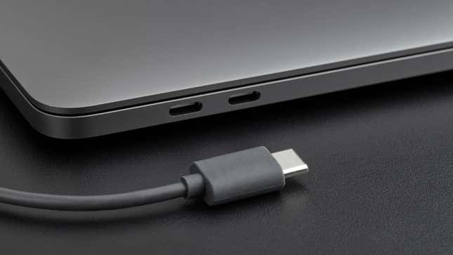 Side close-up photo of grey laptop with grey type-c cable