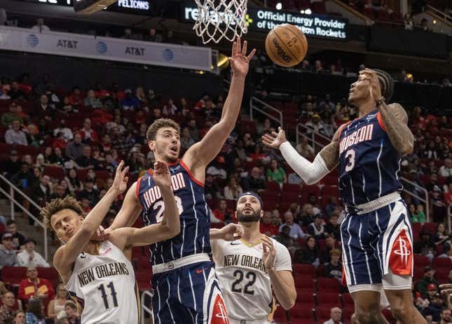 Mar 17, 2023; Houston, Texas, USA; Houston Rockets center Alperen Sengun (28) and guard Kevin Porter Jr. (3) try to grab a rebound against New Orleans Pelicans forward Larry Nance Jr. (22) and guard Dyson Daniels (11) in the first quarter at Toyota Center.