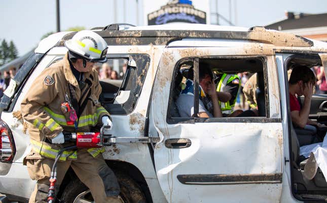 Woodburn Fire Department Assistant Chief Chris Krohn uses the jaws of life to pry a door off a vehicle to rescue South Warren High School seniors Prince Patel and Elly Bennett during a mock car crash at South Warren High School in Bowling Green, Ky., on Friday, April 22, 2022.