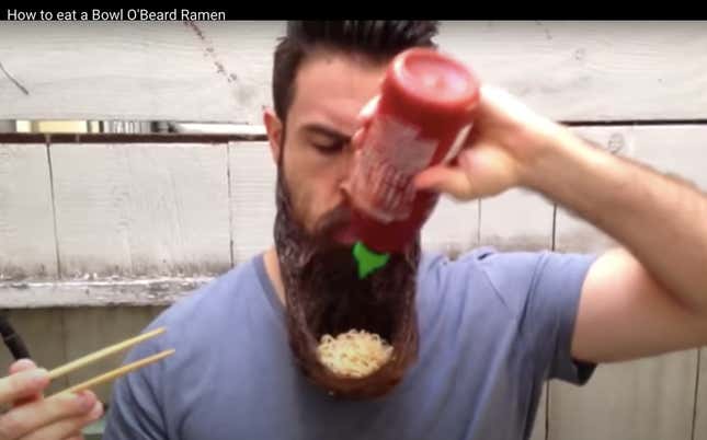 A man, who has fashioned a bowl out of his beard and added ramen noodles to it, douses them with sriracha.