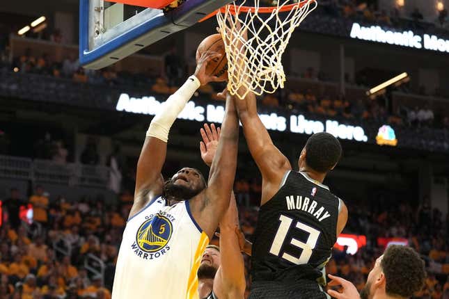 Apr 23, 2023; San Francisco, California, USA; Golden State Warriors forward Kevon Looney (5) reaches for a rebound against Sacramento Kings forward Keegan Murray (13) and forward Domantas Sabonis (lower center) during the third quarter of game four of the 2023 NBA playoffs at Chase Center.
