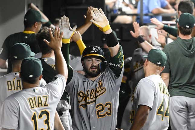 Aug 24, 2023; Chicago, Illinois, USA;  Oakland Athletics catcher Shea Langeliers (23) celebrates in the dugout after he hits a three run homerun against the Chicago White Sox during the fourth inning at Guaranteed Rate Field.