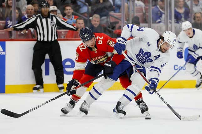 Apr 10, 2023; Sunrise, Florida, USA; Toronto Maple Leafs center Auston Matthews (34) protects the puck from Florida Panthers defenseman Brandon Montour (62) during the first period at FLA Live Arena.