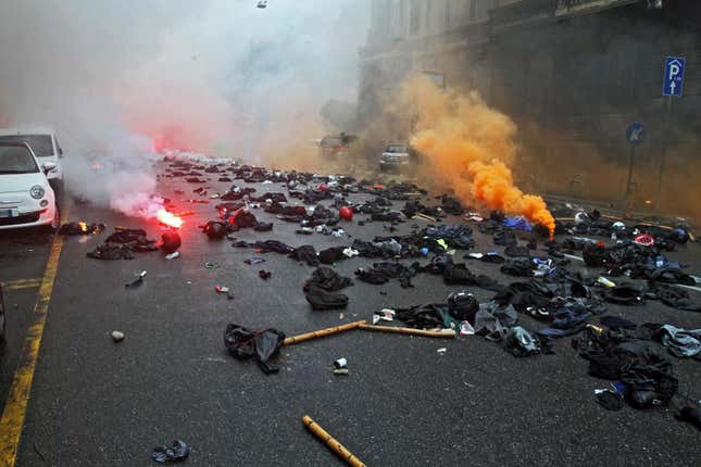 Black uniforms were abandoned on the street in Milan, by protesters who later mixed in with the crowd.
