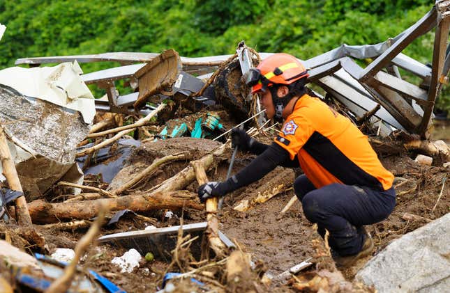 A South Korean rescue worker searching for missing persons after a landslide hit a village following heavy rains on July 16, 2023 in Yecheon, South Korea.