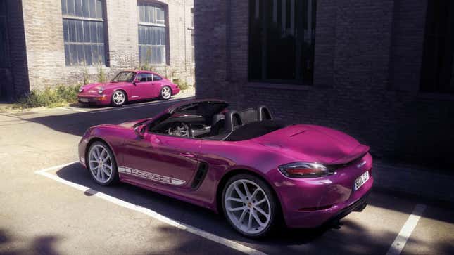 A photo of a pink Porsche Boxster next to a pink Porsche 911