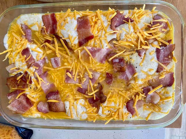 Casserole layered with pancake mix, eggs, bacon, and cheese. Ready to be baked.