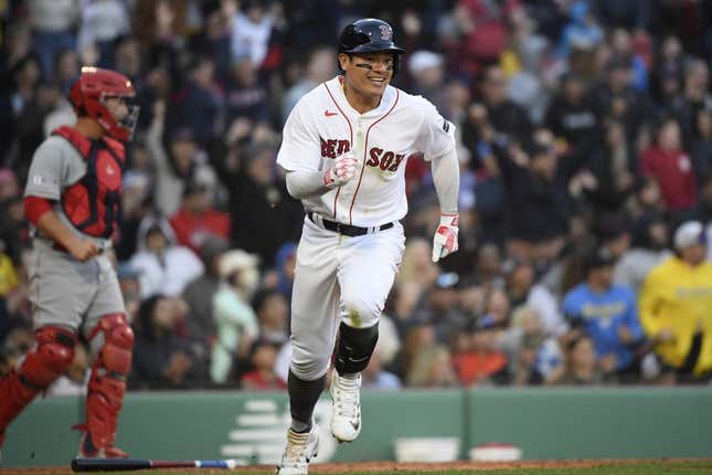 Apr 15, 2023; Boston, Massachusetts, USA; Boston Red Sox catcher Connor Wong (12) runs to first after hitting an RBI single during the eighth inning against the Los Angeles Angels at Fenway Park.