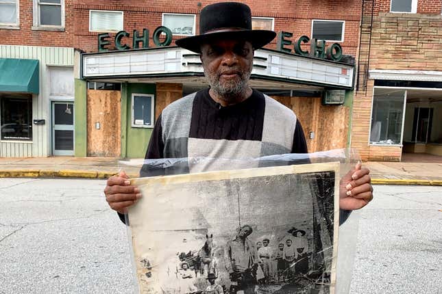 In this, Jan. 13, 2020 file photo, Rev. David Kennedy stands outside the Echo Theater holding a photo of his great uncle’s lynching, in Laurens, S.C. Kennedy has fought for civil rights in South Carolina for decades.