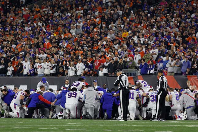 Buffalo Bills players huddle after teammate Damar Hamlin #3 collapsed following a tackle against the Cincinnati Bengals during the first quarter at Paycor Stadium on January 02, 2023 in Cincinnati, Ohio. (Photo by Kirk Irwin/Getty Images)