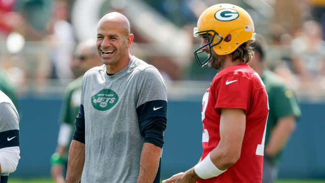 New York Jets head coach Robert Saleh laughs with Green Bay Packers quarterback Aaron Rodgers during a joint training camp practice.