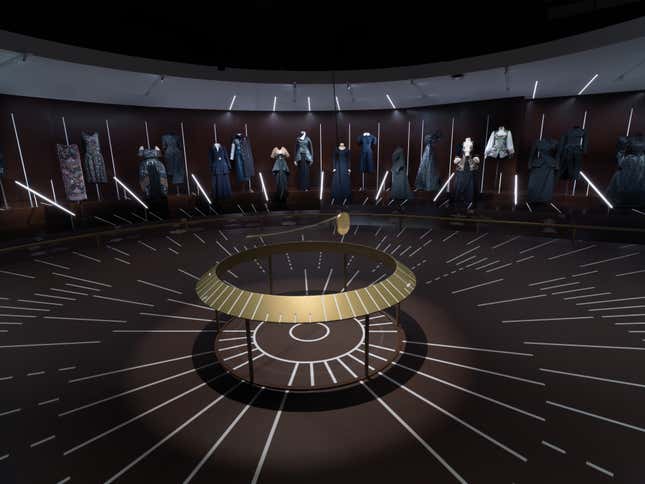 A gallery centered on a giant clockface in the new fashion exhibit at the Met