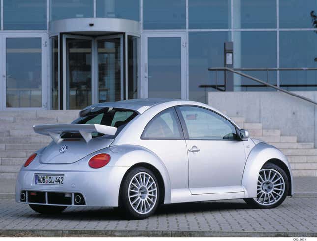 A silver 2001 VW Beetle RSi is parked in front of a building, rear-three-quarter view