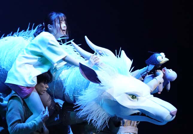 Chihiro flies with Haku in Dragon form