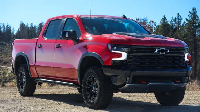 red 2023 chevy silverado zr2 parked on a dirt road, viewed from the front right-hand corner of the vehicle
