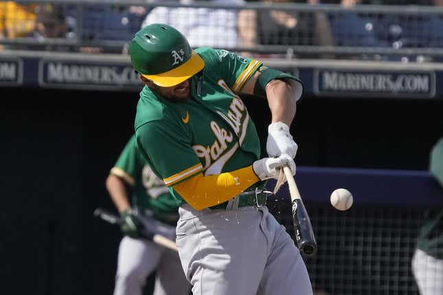 Mar 5, 2023; Peoria, Arizona, USA; Oakland Athletics third baseman Kevin Smith (4) breaks his bat against the San Diego Padres in the third inning at Peoria Sports Complex.